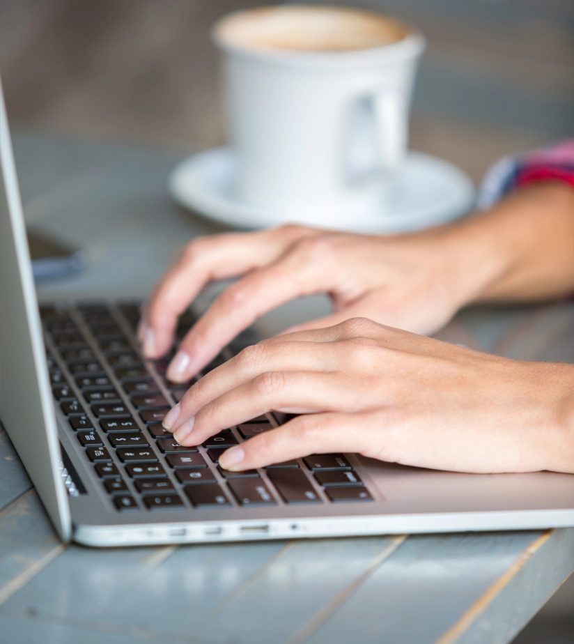 About_vertical_female white hands on laptop